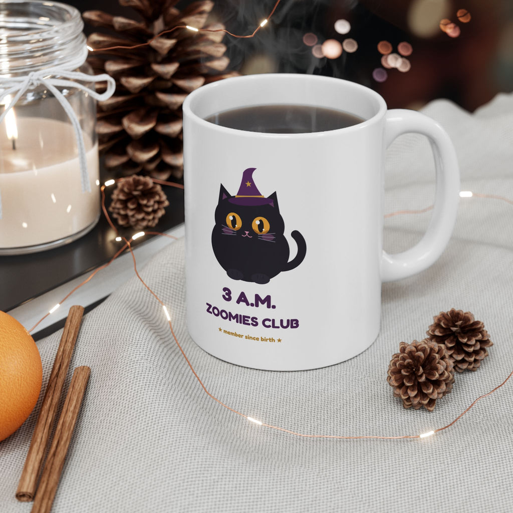 Hex Zoomies Club mug on a cosy table