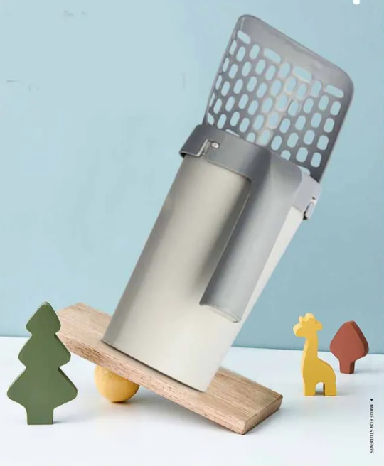 Litter scoop resting in its stand