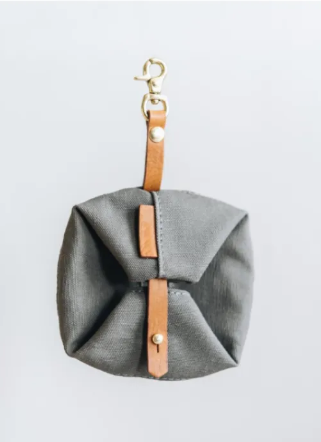 Grey foldable travel bowl folded with clip