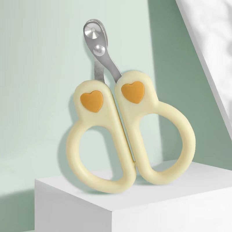 Cream cat nail clippers with heart detail