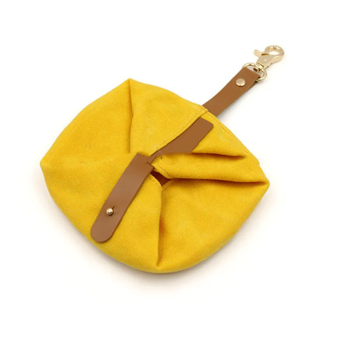 Yellow foldable canvas travel bowl with leather strap