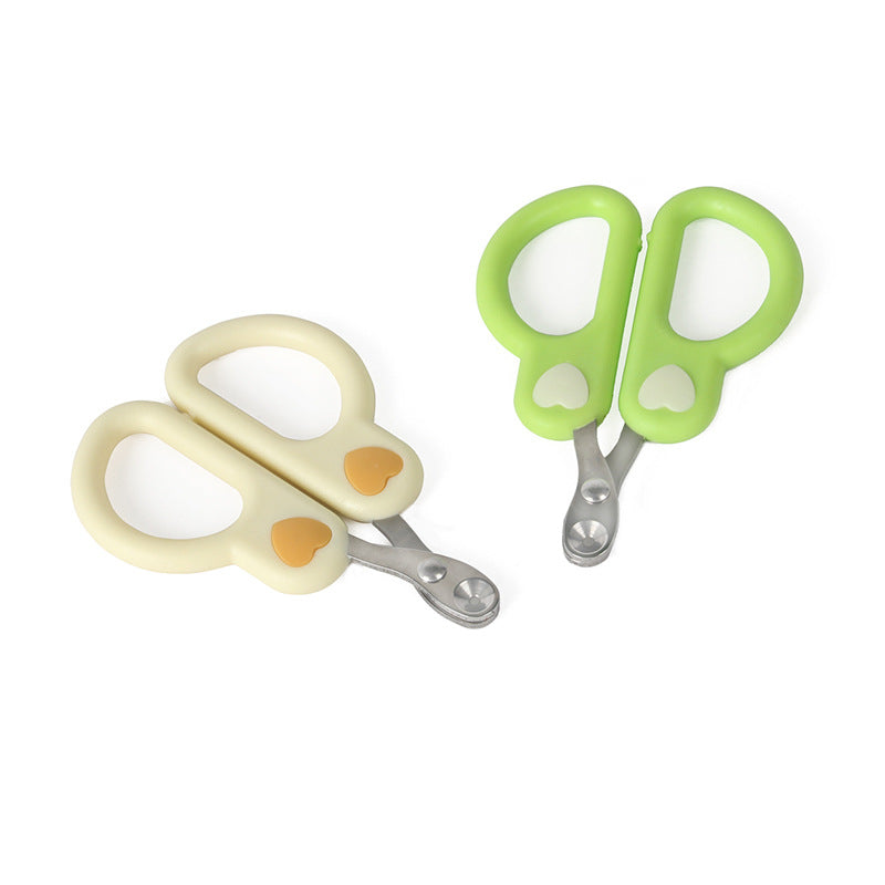 Green and cream cat nail clippers side by side