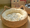 Handwoven cattail cat bed with soft cream cushion
