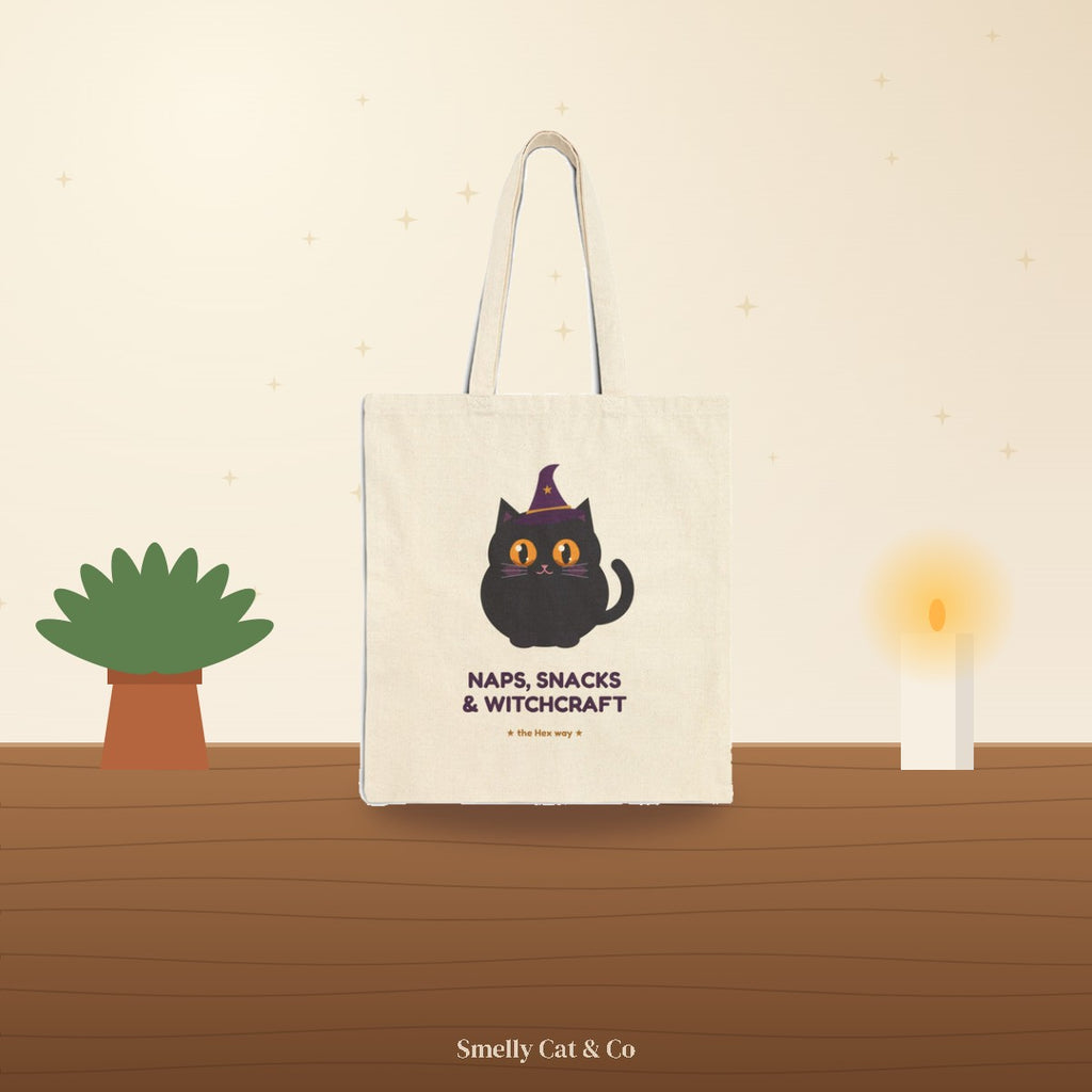 Hex Naps, Snacks & Witchcraft tote bag on a cozy wooden table (product photo on an illustrated background)